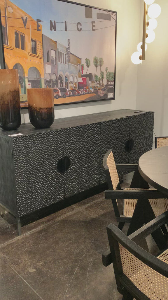 This Athens Sideboard has a textured surface that brings a unique look to any room. The doors open to two spacious shelves, perfect for storing your extra linens, china, or other things around the house.  Reclaimed Pine on Iron Frame Black Stained and Sealed Wood and Antique Iron Size: 79"l x 20"d x 35"h 