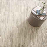 Inspired by substrate layers of sandstone sediments that chronicle the millennia, this luxurious, irregularly striped wool rug will stand the test of time. The subtle degradations of a natural undyed fleece pile enhance the finely observed irregular striping in a softly mineral palette. The subtle beauty of the higher sheared tufts emphasizes the contrast of the densely looped stripes. Amethyst Home provides interior design, new construction, custom furniture, and area rugs in the Washington metro area.