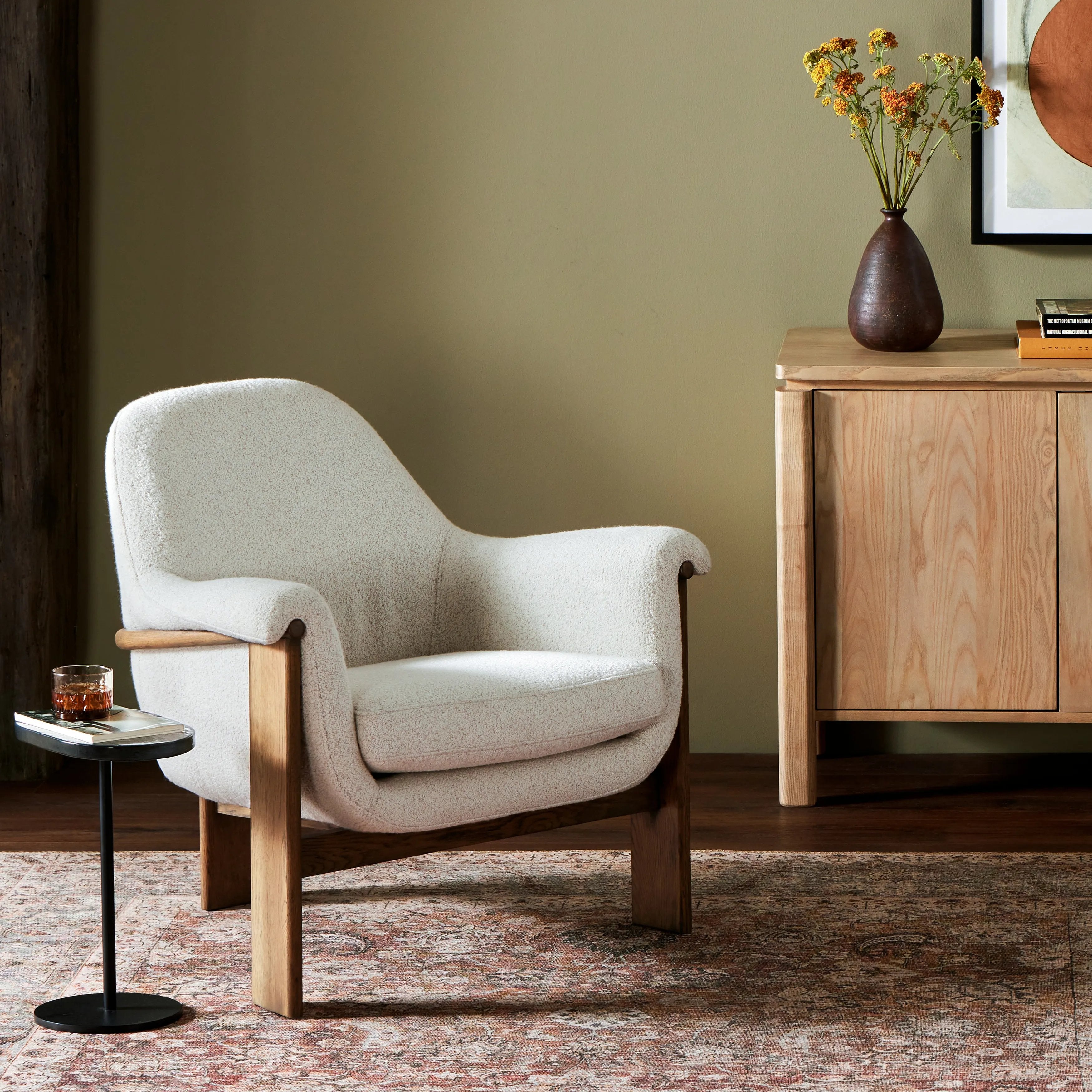 Comfort and style meet on this vintage-inspired accent chair. A curvy silhouette, classic rolled arms and loose seat cushion are paired with an exposed wood frame for a fresh new take. Upholstered in a texture-forward boucle performance fabric. Amethyst Home provides interior design, new home construction design consulting, vintage area rugs, and lighting in the Houston metro area.